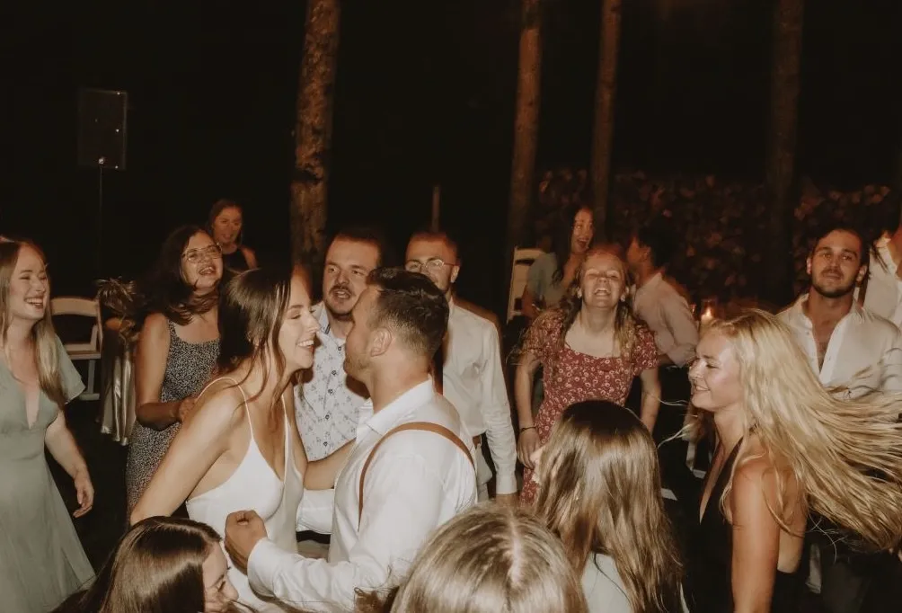Wedding guests dancing together at the reception